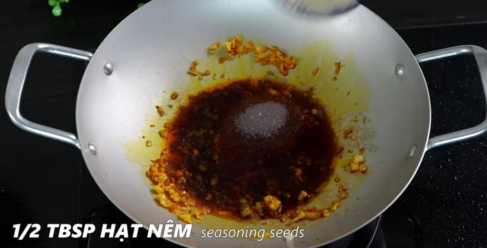Add soy sauce, sugar, seasoning powder, MSG, five-spice powder, chili sauce, and coconut water to the pan. Stir well.