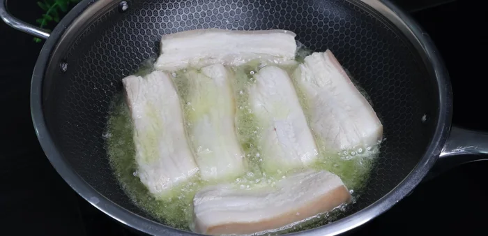 Fry the pork until golden brown on both sides.