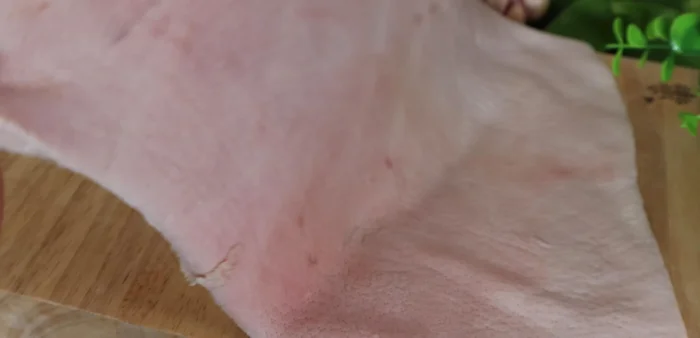 Prepare the pork skin: Choose a rectangular piece (approx. 30x25cm), and sprinkle with half a tablespoon of salt. Scrape the skin clean, ensuring it's thoroughly cleaned before use.
