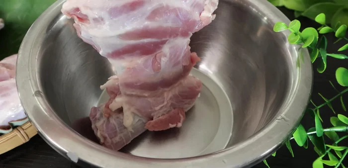 Place the pork leg in a basin. If purchasing pre-cut, ensure bones are removed. Clean the pork leg, removing any excess sinew.