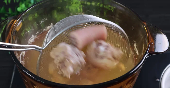 Simmer the pork bones in a separate pot for about 30 minutes.