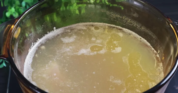 Add the pork skin to the simmering pork bone broth.