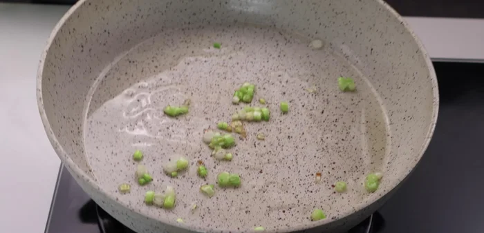 Turn off the heat and add sugar, seasoning powder, fish sauce, chili sauce, and water to the pan. Stir to combine.