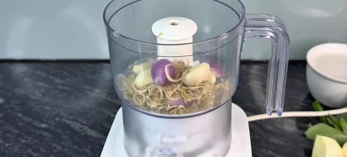 Grind onion, garlic, and lemongrass in a mortar.