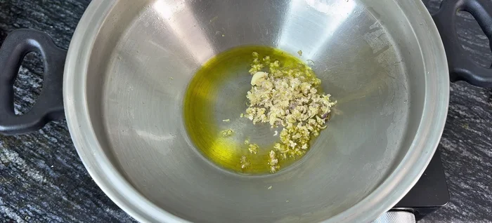 In the same pot, sauté onions, garlic, and lemongrass until fragrant.