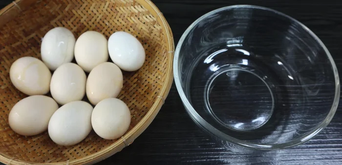 Crack the boiled balut eggs into a bowl.