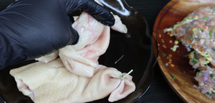 Stuff the meat mixture into the duck necks, pressing firmly and tying securely.
