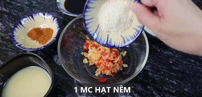 In a bowl, combine the garlic-chili paste with salt, ground pepper, soy sauce, five-spice powder, condensed milk, and sesame oil.