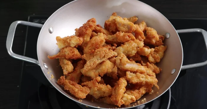 Add the fried chicken to the sauce, reduce heat, and toss until evenly coated.