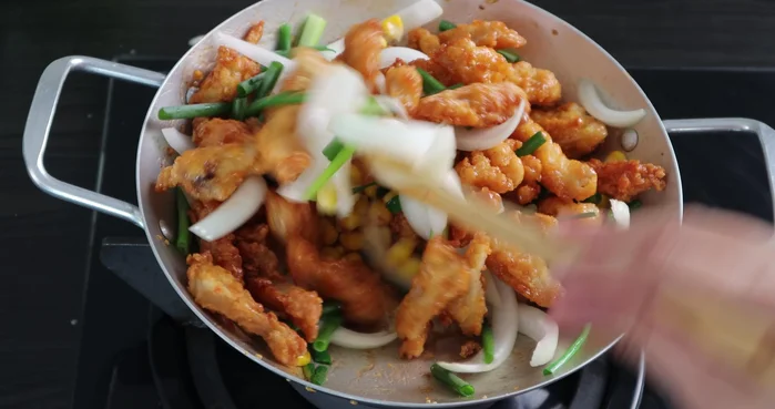 Add the onions, green onions, and corn. Stir well. Turn off the heat.