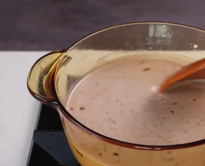 Cook the mixture over low heat, stirring regularly to prevent burning, until it boils.