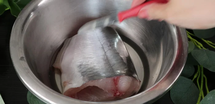 Rinse the fish with warm water (70 degrees). Scrape the fish skin with a knife to remove slime. Rinse again.