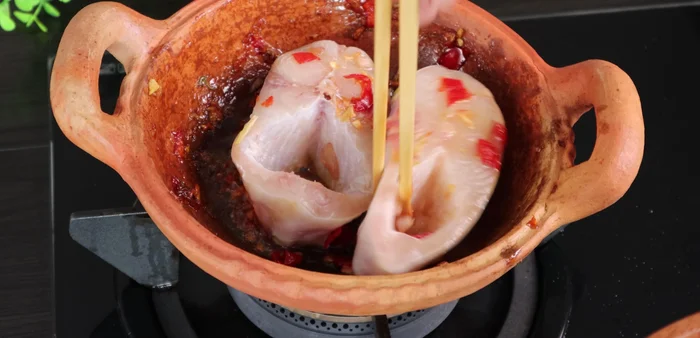 Add the fish and cook until firm on both sides. Return the pork to the pan.