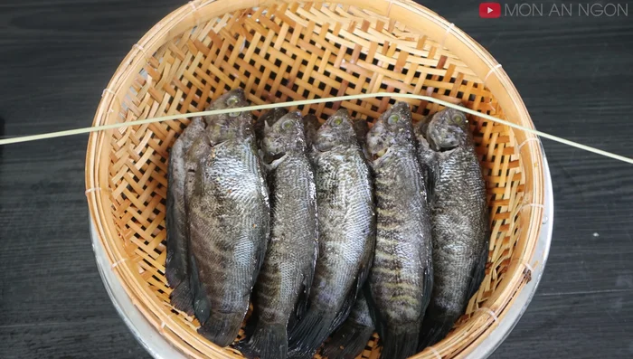 Thread the fish onto a string, preparing for drying.