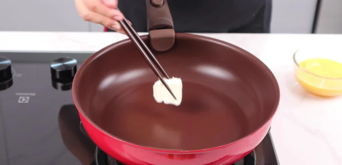 Melt butter in a shallow pan.