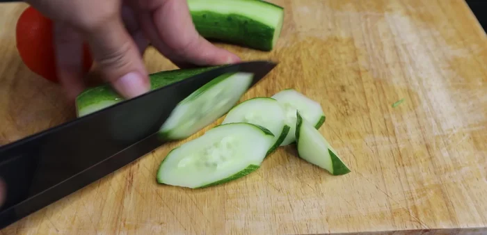 Prepare cucumbers and tomatoes for serving.