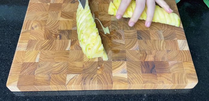 Prepare the vegetables: chop pineapple, tomatoes, onions, lemongrass, ginger, and garlic.