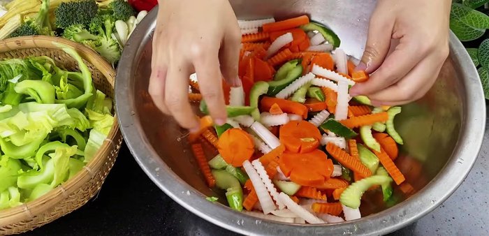 Drain and squeeze vegetables: After an hour, drain the salted vegetables and squeeze out excess water.