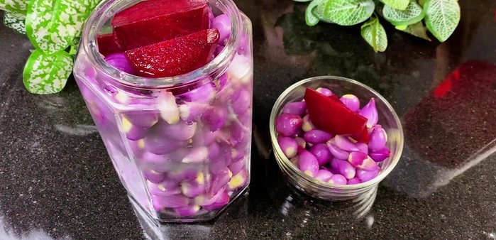 Pack and soak: Drain the soaked onions and pack them tightly into sterilized glass jars. Pour the pickling liquid over the onions, ensuring they are completely submerged. Add a few beetroot slices on top to keep the onions submerged.