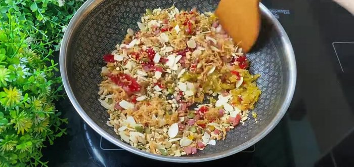 Add unroasted ingredients (jackfruit, pumpkin seeds, lotus seeds) and mix well. Stir in banh deo flour.
