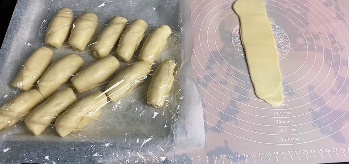 Roll out the dough balls, creating thin layers. Place a filling ball in the center, wrap and seal.