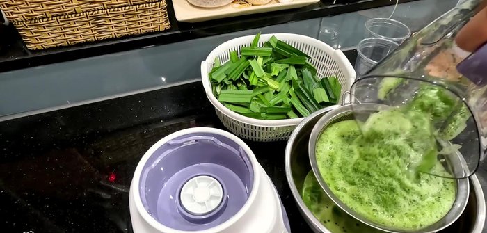 Strain the pandan mixture through a sieve and squeeze out all the juice from the leaves.