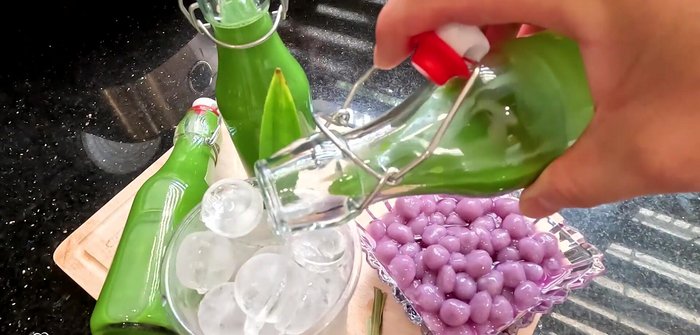 To serve, fill a glass with crushed ice, add pineapple milk dessert, and top with marinated taro pearls.