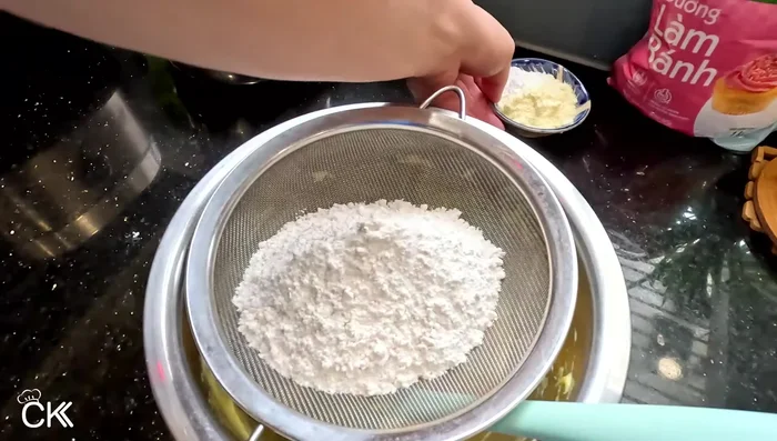 Gradually add flour, milk powder, and baking powder. Mix well until smooth.