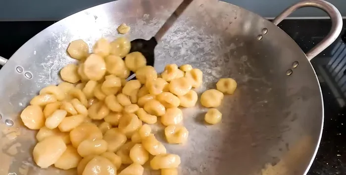 Continue stirring until the sugar water dries up and forms tiny white crystals at the bottom of the pan. This takes about 15-20 minutes. (359)
