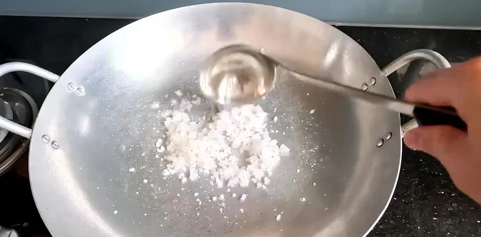 Roast the coarse salt in a pan, crushing larger grains as you go.