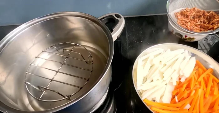 Assemble the spring rolls: Fill rice paper wrappers with your prepared ingredients and roll tightly.