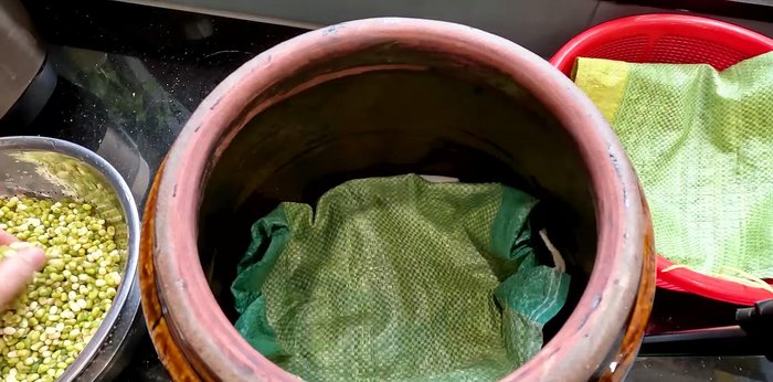 Place the soaked green beans inside the rice bag on top of the rice bag layer.