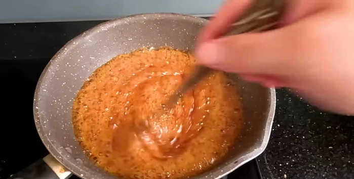 Turn off the heat. Add boiling water (avoid cold water to prevent splattering). Stir until completely dissolved.