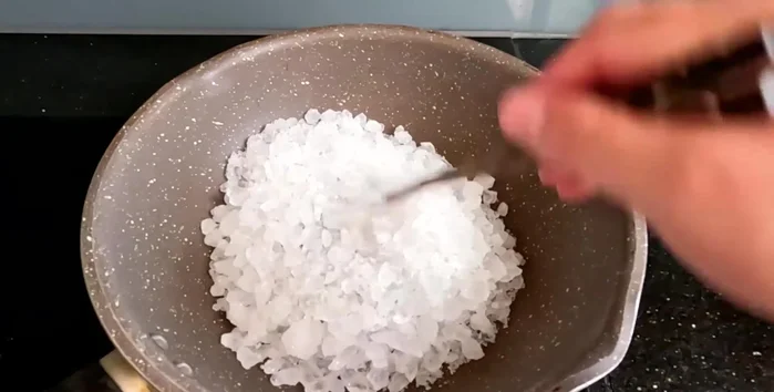 Place all the rock sugar in a pan. Cook over low heat (or medium/high if experienced) until melted. Stir frequently to prevent burning.