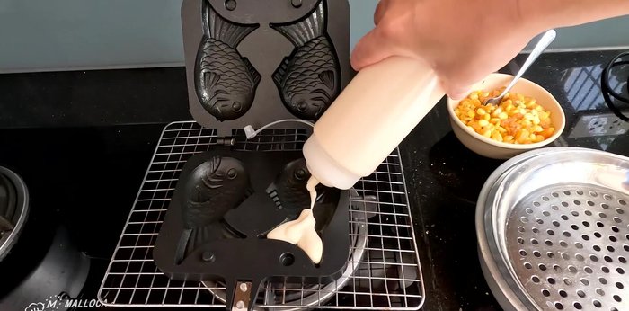 Fill the mold: Using a bottle, dispense batter into each mold, filling about halfway (402.24). Add the prepared topping.