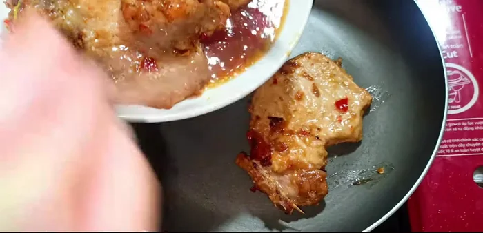 Transfer the fried ribs to another pan. Add fresh coconut water and the remaining marinade to the pan.