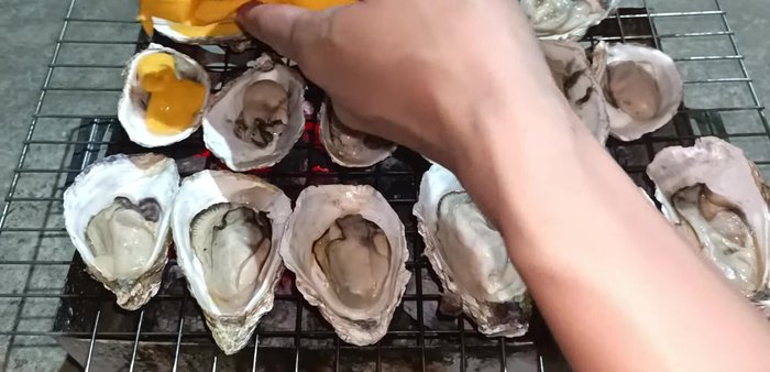 Pour the prepared sauce over the grilled oysters.