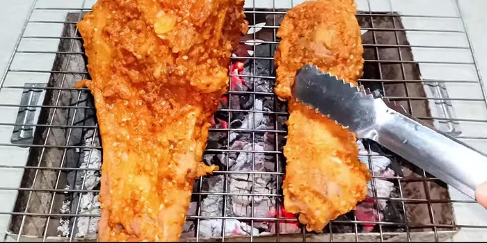 Grill the marinated pig's cheeks, turning occasionally, until golden brown and crispy.
