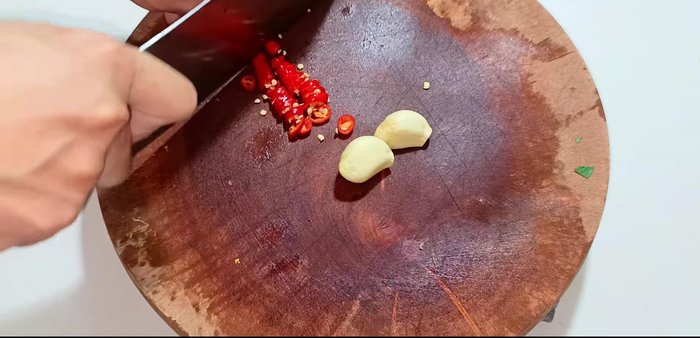Finely chop chili and garlic for the dipping sauce.