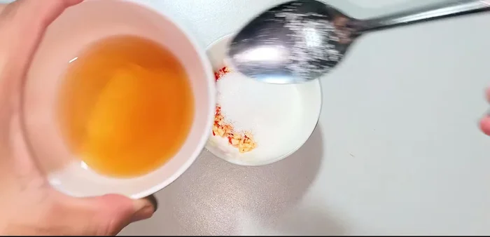 Prepare the dipping sauce: 2 tablespoons sugar, 2 tablespoons fish sauce, and 1 tablespoon lemon juice. Stir until the sugar dissolves.