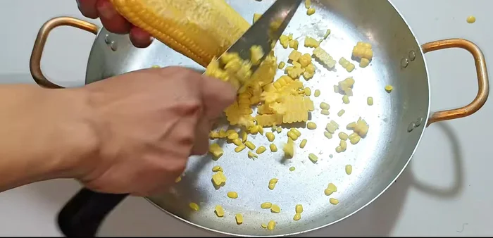Cut the corn kernels off the cob.