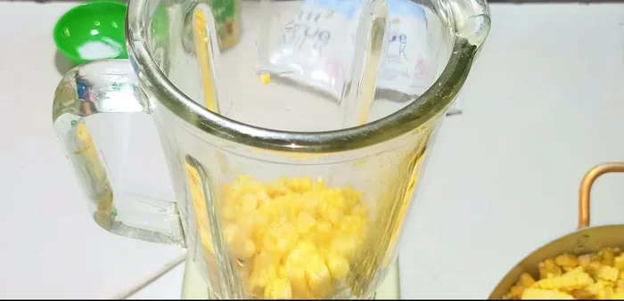 Grind the corn kernels in a blender in three batches. Ensure a smooth consistency.