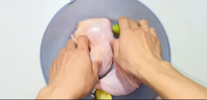 Wash and clean chicken thighs. Poke holes in the meat with a knife to help marinate and cook faster.