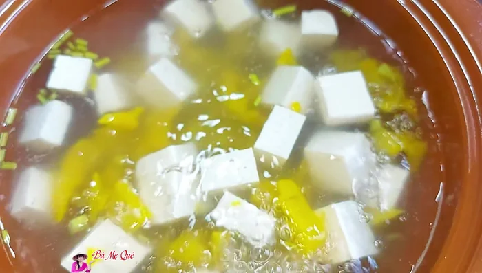 Cut tofu into small pieces and add it to the soup along with coriander stalks.