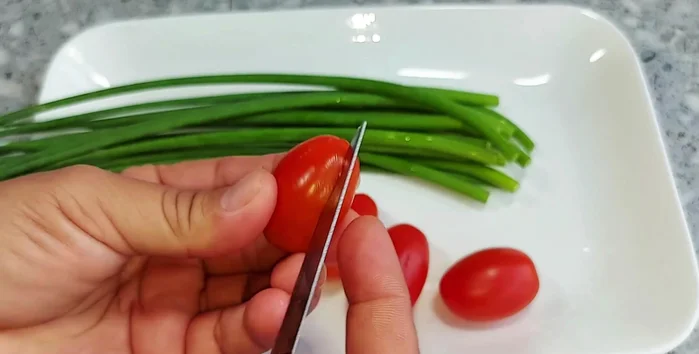 Prepare eggplant flowers for garnish: Divide the eggplant into four equal parts, cut down about halfway, and carve out petals without cutting too deep. Insert chives into the top of the eggplant to form a flower.