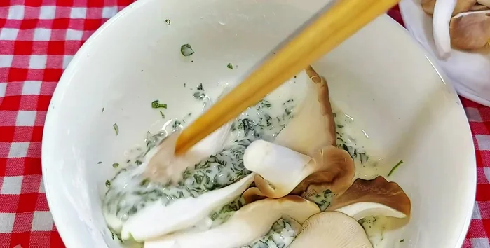 Add the torn mushrooms to the batter and mix well to coat evenly.