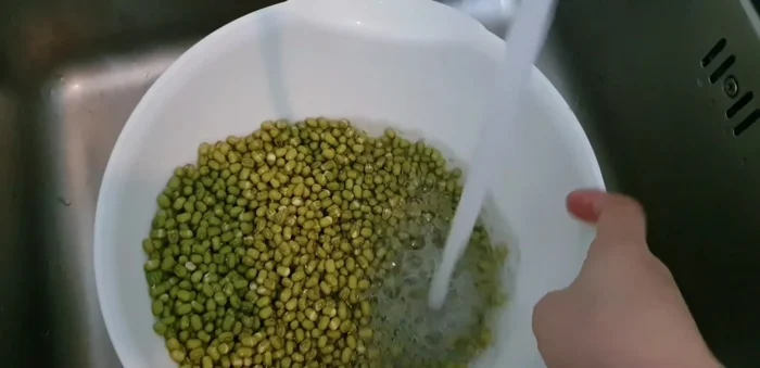 After soaking, drain the excess water and cover the container with a cloth.