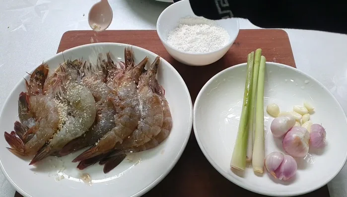 Prepare the aromatics: Finely mince some lemongrass and dried onions. Add to the marinated shrimp for extra flavor.