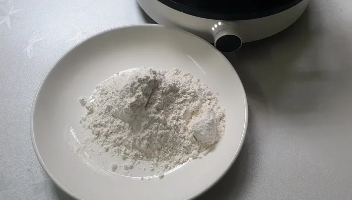 Coat chicken thighs in the flour mixture, then add a layer of dry flour.
