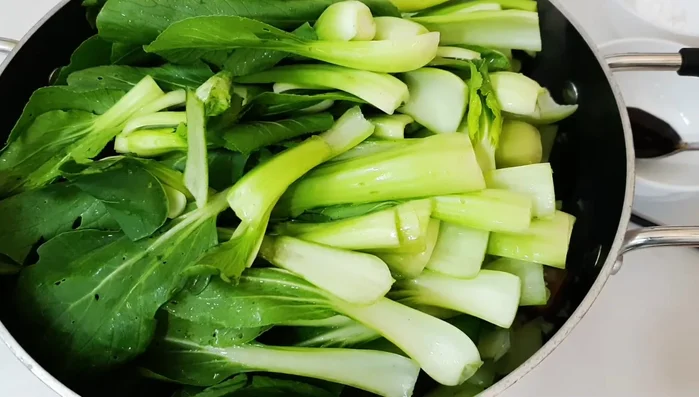 Add the remaining cabbage and 2 tablespoons of water. Stir-fry until cooked but still green.